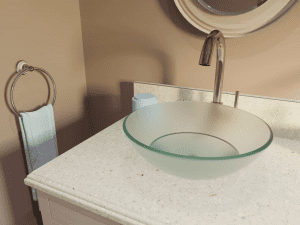 Beautiful countertop in Ivory Crush with modern glass bowl sink.